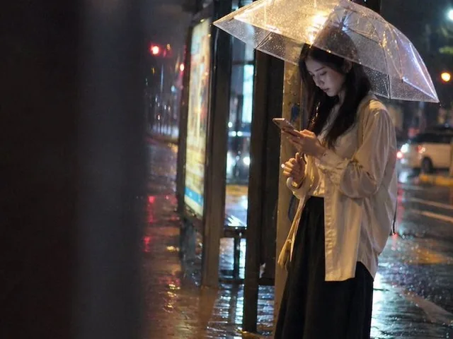 Cinematic rainy night bus stop prompt preview image 1